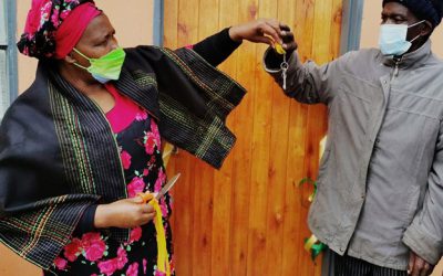 MEC Nonceba Kontsiwe giving keys to Mr Siyeke to open his new house during a house handover in Chanti Village near Qunu in the Eastern Cape.