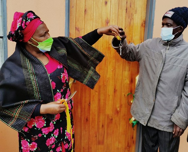 MEC Nonceba Kontsiwe giving keys to Mr Siyeke to open his new house during a house handover in Chanti Village near Qunu in the Eastern Cape.