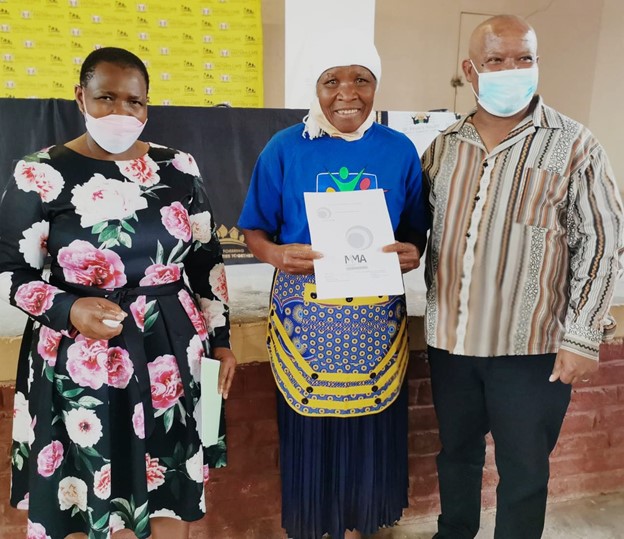 MEC Nonceba Kontsiwe handing over title deeds to beneficiaries with the Mayor of Steytlerville Cllr Deon de Vos.