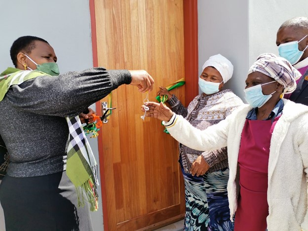 MEC Nonceba Kontsiwe handing over keys of a brand-new home to the destitute beneficiary in Tolofiyeni village.
